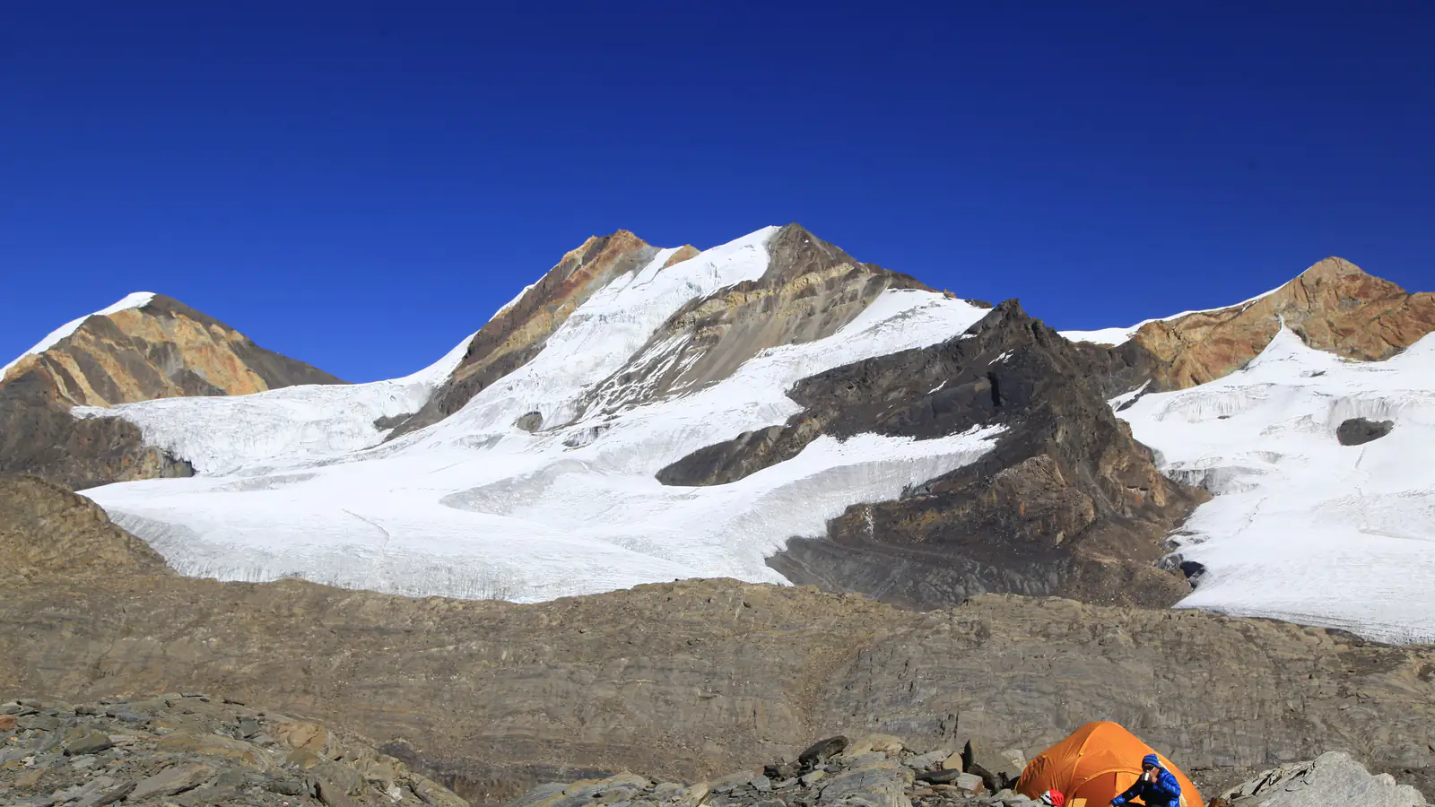 A person sitting by a tent above Manang, Nepal